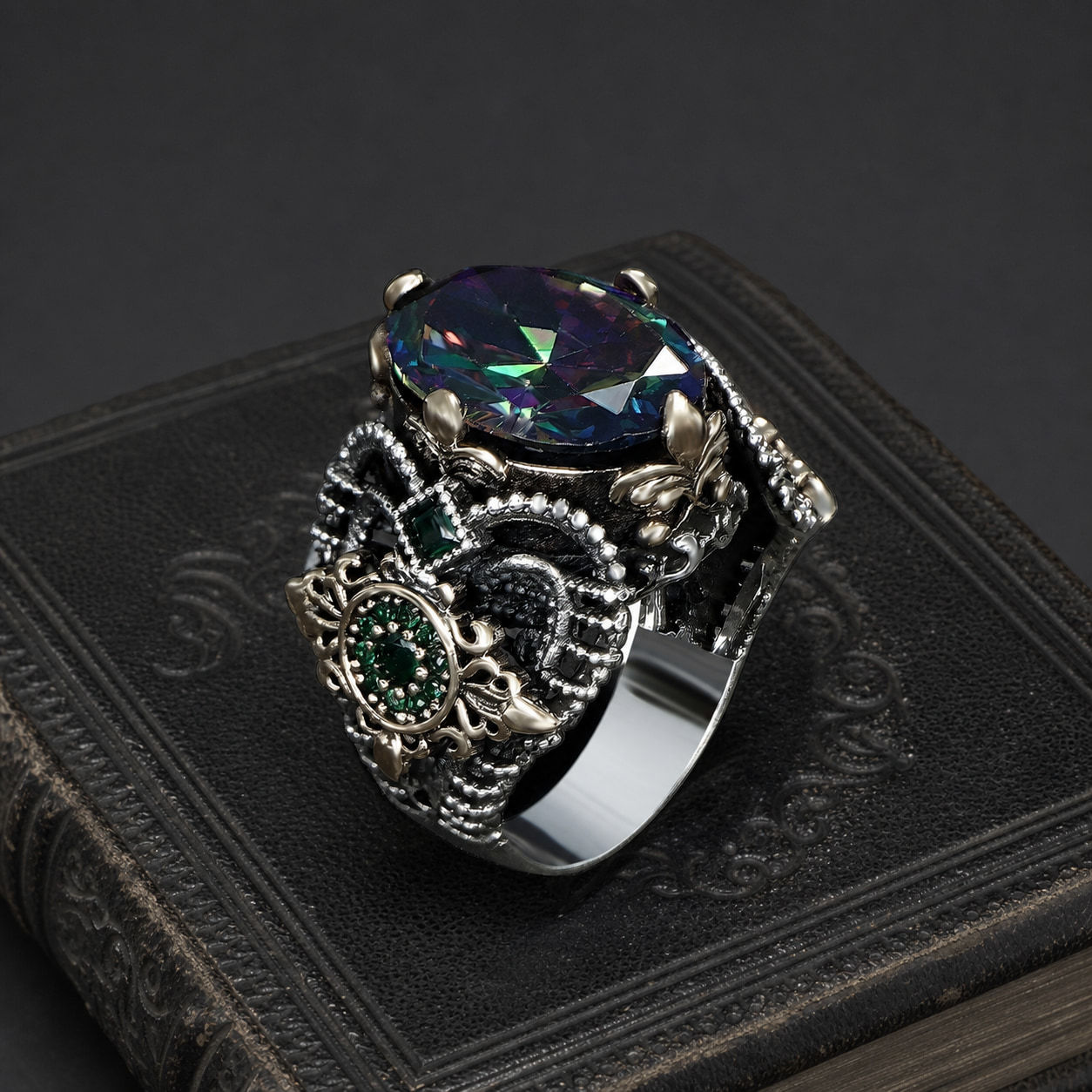 Mystic Topaz Floral Sterling Silver Men's Ring on a black leather book