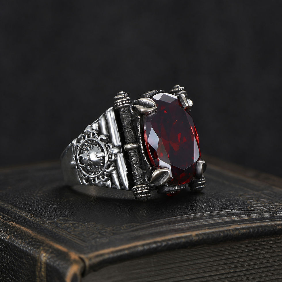 サムネイル： Red Zircon Wheel Emblem Sterling Silver Men's Ring on a black leather antique book