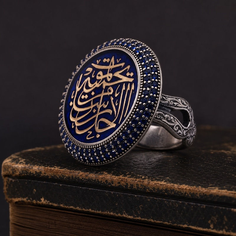 Destiny Guardian Blue Calligraphy Sterling Silver Ring side view on a dark leather book