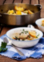 Baked cod with lemon and herbs, served with roasted Brussels sprouts and a small sweet potato.