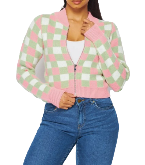 A woman wearing a zip-up cropped pink and green sweater cardigan.