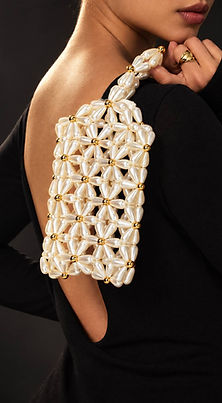 Woman holding a mini pearl tote over her shoulder. Available at Purse Swag Boutique.