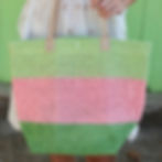 Stunning pink and green straw beach tote with vegan leather straps.