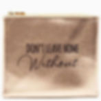 Metallic gold cosmetic bag with the phrase "Don't Leave Home Without" printed on the front.