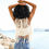 Thumbnail: Women at beachside wearing cream bohemian crochet vest 