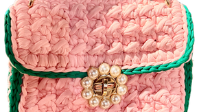 Beautiful handmade sorority-inspired pink and green crochet crossbody bag with pearl closure..