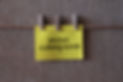 photo coming soon text on a yellow sticky note with three clips.jpg