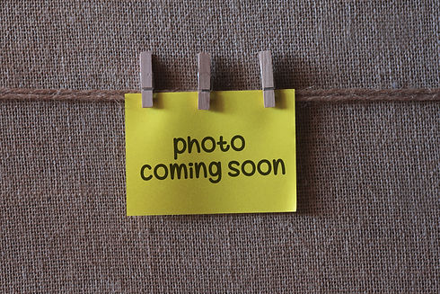 photo coming soon text on a yellow sticky note with three clips.jpg