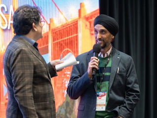 Jaspreet Sachdev onstage at the OpenLAN Global Summit at WWC 2026