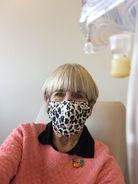Rolynn Anderson with leopard print face mask sitting with an IV drip