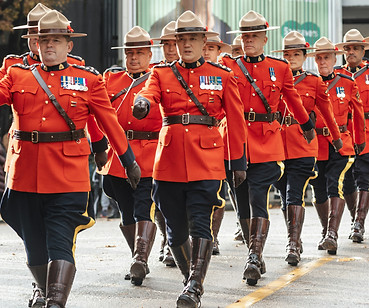 a group of men in red uniforms marching