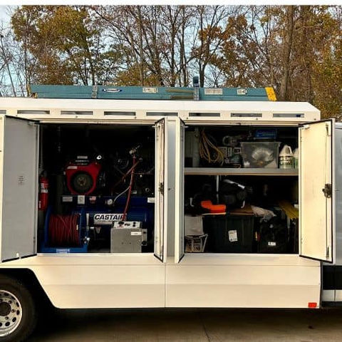 Open service trailer compartments with tools and equipment