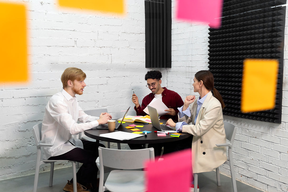 full-shot-colleagues-sitting-table.jpg