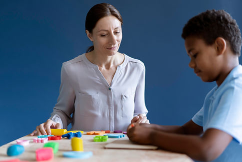 boy-doing-occupational-therapy-session-with-psychologist.jpg
