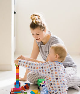 boy-with-mom-playing-colorful-building-kit.jpg