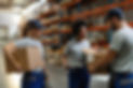 happy-african-american-woman-her-coworkers-examining-packages-while-working-distribution-w