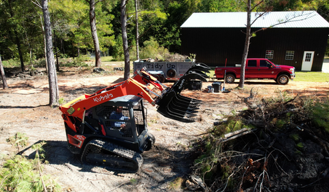 Kubota Skid Steer cleaning up trees and debris