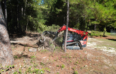 Kubota Skid Steer cleaning up trees and debris
