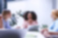 alt=_employees chatting in a workplace