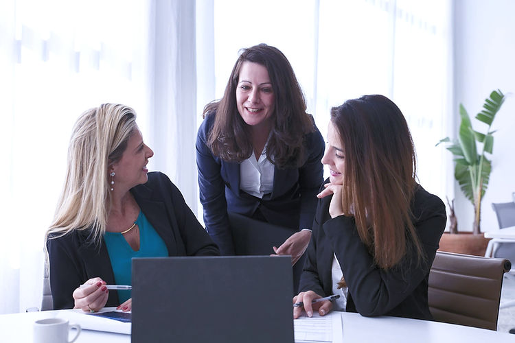 alt=" 3 professional women in the workplace chatting"