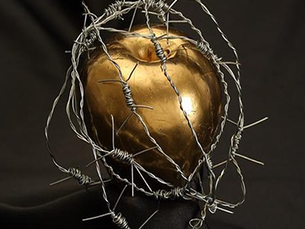 Golden apple wrapped in barbed wire