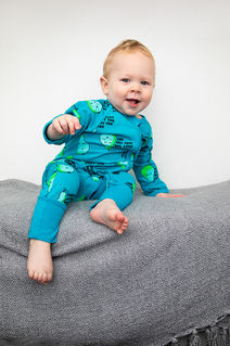 baby in a pear sleep suit