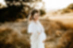 beautiful pregnant mother holding her baby bump in a white dress with sunset behind her, Petaluma California, maternity photography