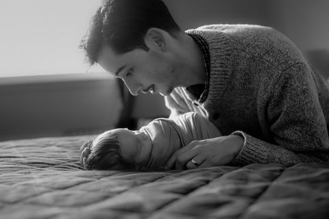 parent and infant on bed