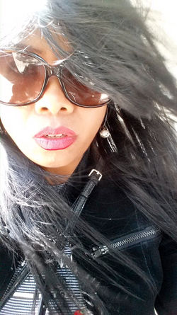 Utami Fraisl with sunglasses and black jacket