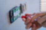 Technician installing sensor light switch at modern villa.jpg