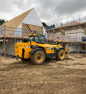 New Build site with JCB tele handler in front of the new build