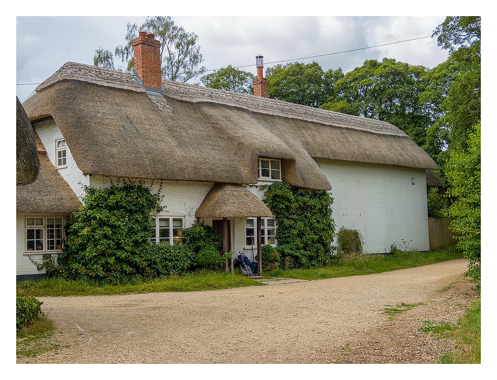 One of several thatched cottages after the ford
