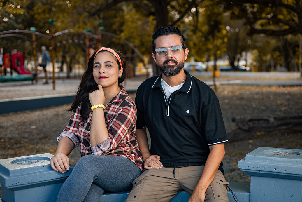 Couple dressed elegantly by a vintage car during golden hour in Puerto Rico