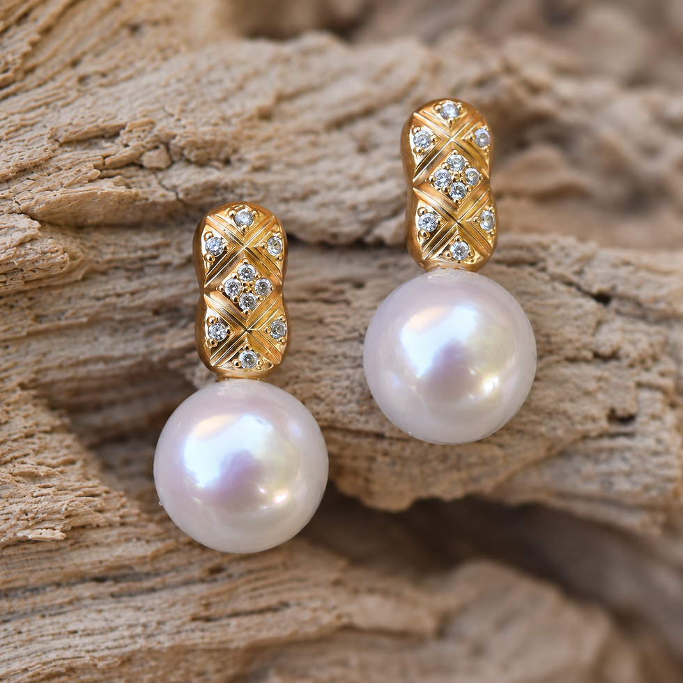 Thumbnail: White pearl earrings on a wood background