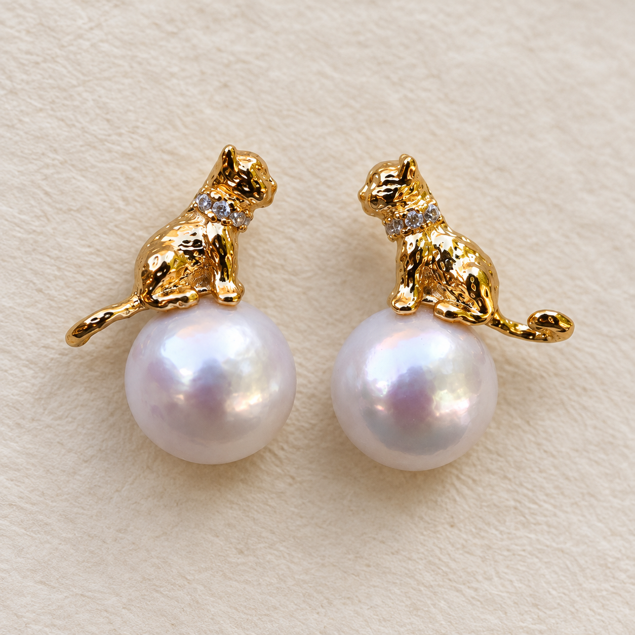 Curious Cat freshwater pearl earrings on ivory background