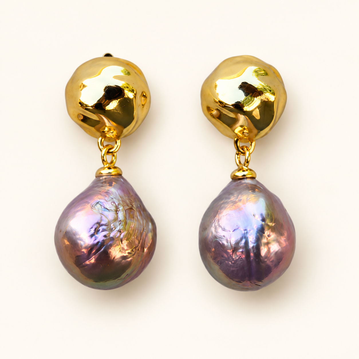 Pebble Glow pearl drop earrings on an off-white background