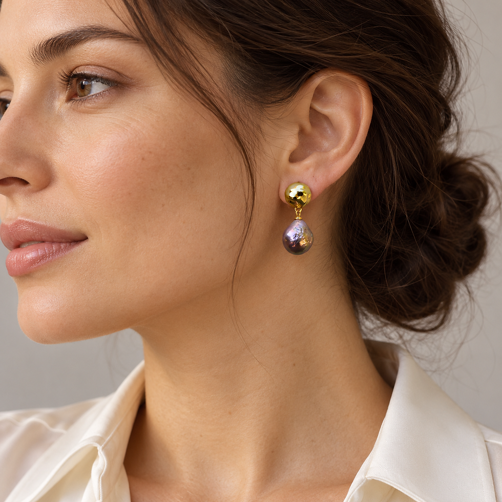 Model wearing Pebble Glow pearl drop earrings with an ivory blouse