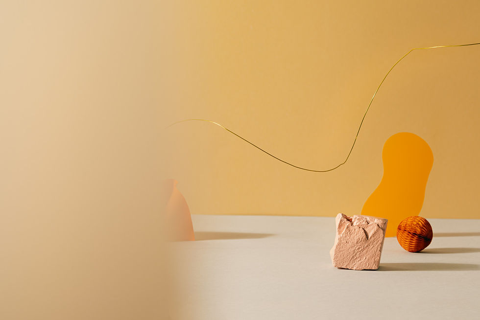 Minimalistische Komposition aus orangefarbenen Formen, warmem Beige und natürlichen Materialien, die eine ruhige und zugleich warme räumliche Atmosphäre erzeugt.