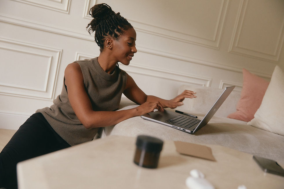Frau arbeitet mit einem Laptop in einem Wohnraum und lernt Interior Design flexibel von zu Hause