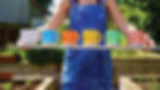 GIRL HOLDING BOARD WITH MUGS.jpg