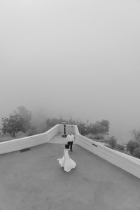 cinematic griffith observatory engagement photos overlooking los angeles skyline in dreamy foggy atmosphere