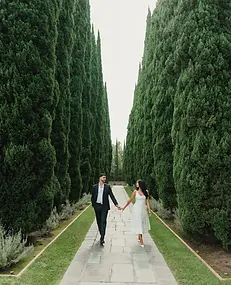 Los Angeles wedding photographer capturing couple walking through cypress garden path