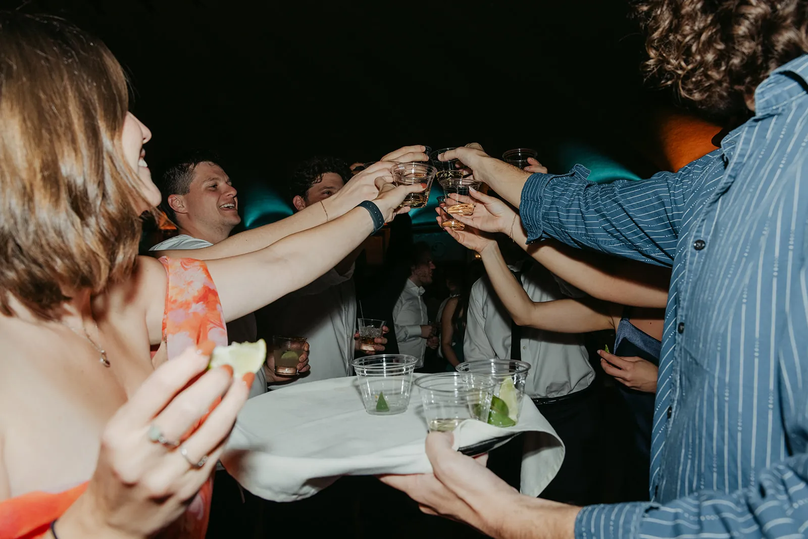 Guests toasting tequila shots during the Catalina Island Casino wedding reception, laughing and celebrating on the dance floor