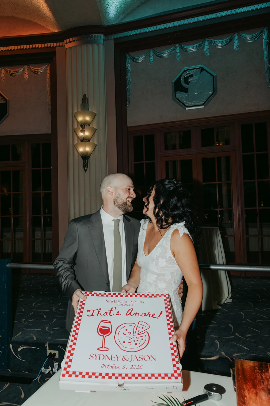 bride and groom with their pizza at the catalina island casino wedding