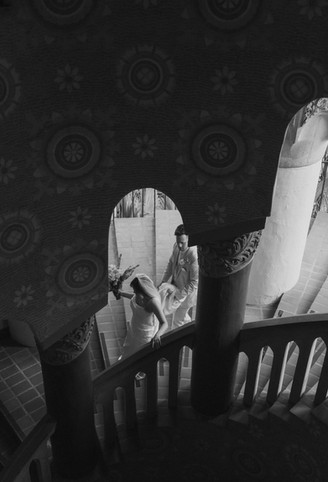 black and white wedding portrait under courthouse archway santa barbara