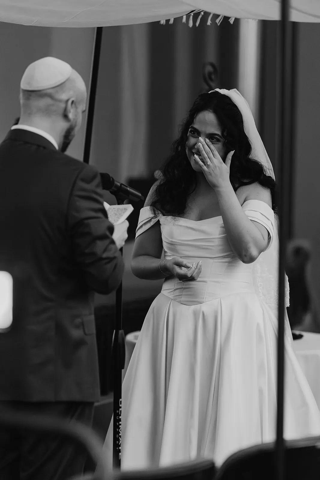Bride wiping tears during the wedding vows inside the Avalon Theatre at the Catalina Island Casino, black and white