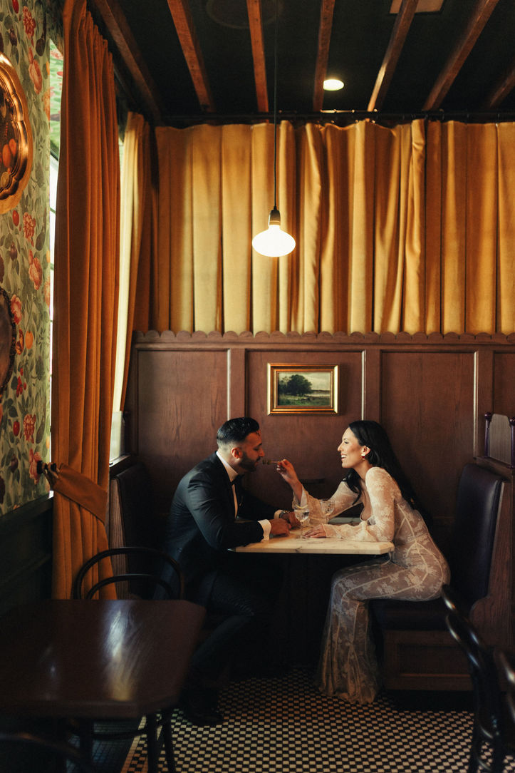 Couple sitting in a moody restaurant booth at Donna's in Echo Park for their Los Angeles engagement photos