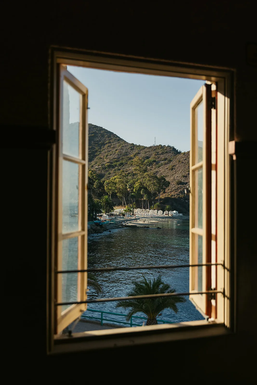 Open Casino Ballroom window framing a view of Descanso Beach and the Catalina Island hills, showing why couples choose this venue for a destination wedding