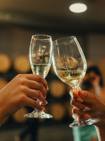 Guests clinking champagne glasses during wedding cocktail hour