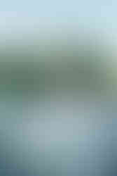 Bride and groom seated at their reception table on the terrace in San Juan Capistrano